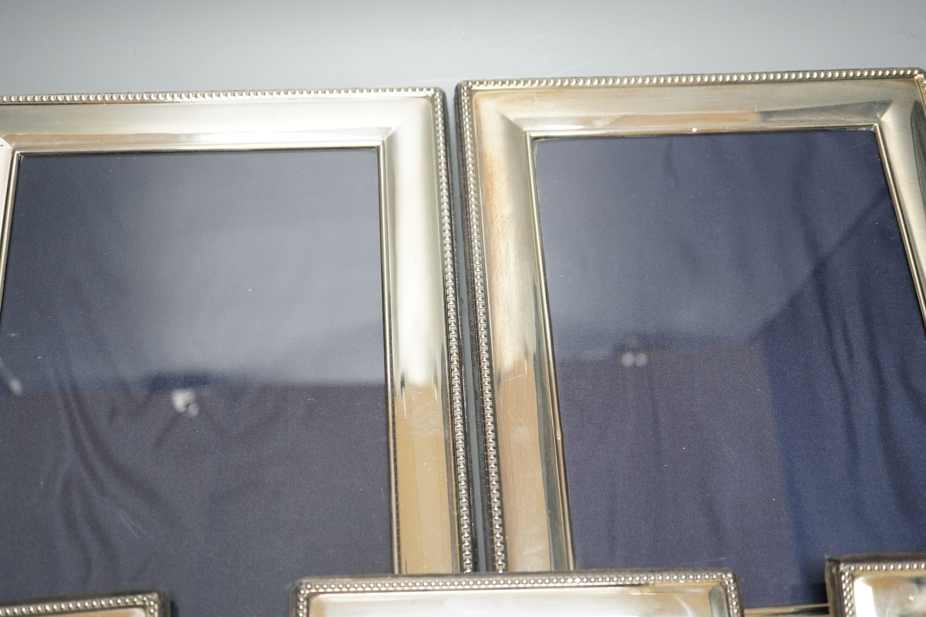 A modern pair of silver mounted photograph frames, Carrs of Sheffield, 2001, 26cm, and a set of three smaller frames, same maker, 2000, 20.2cm